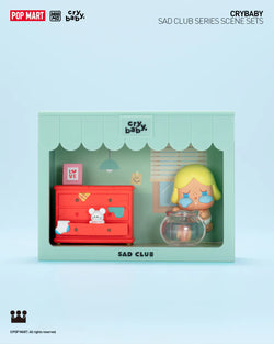 A toy box with a doll and a fish bowl from CRYBABY Sad Club Scene Sets Blind Box Series.