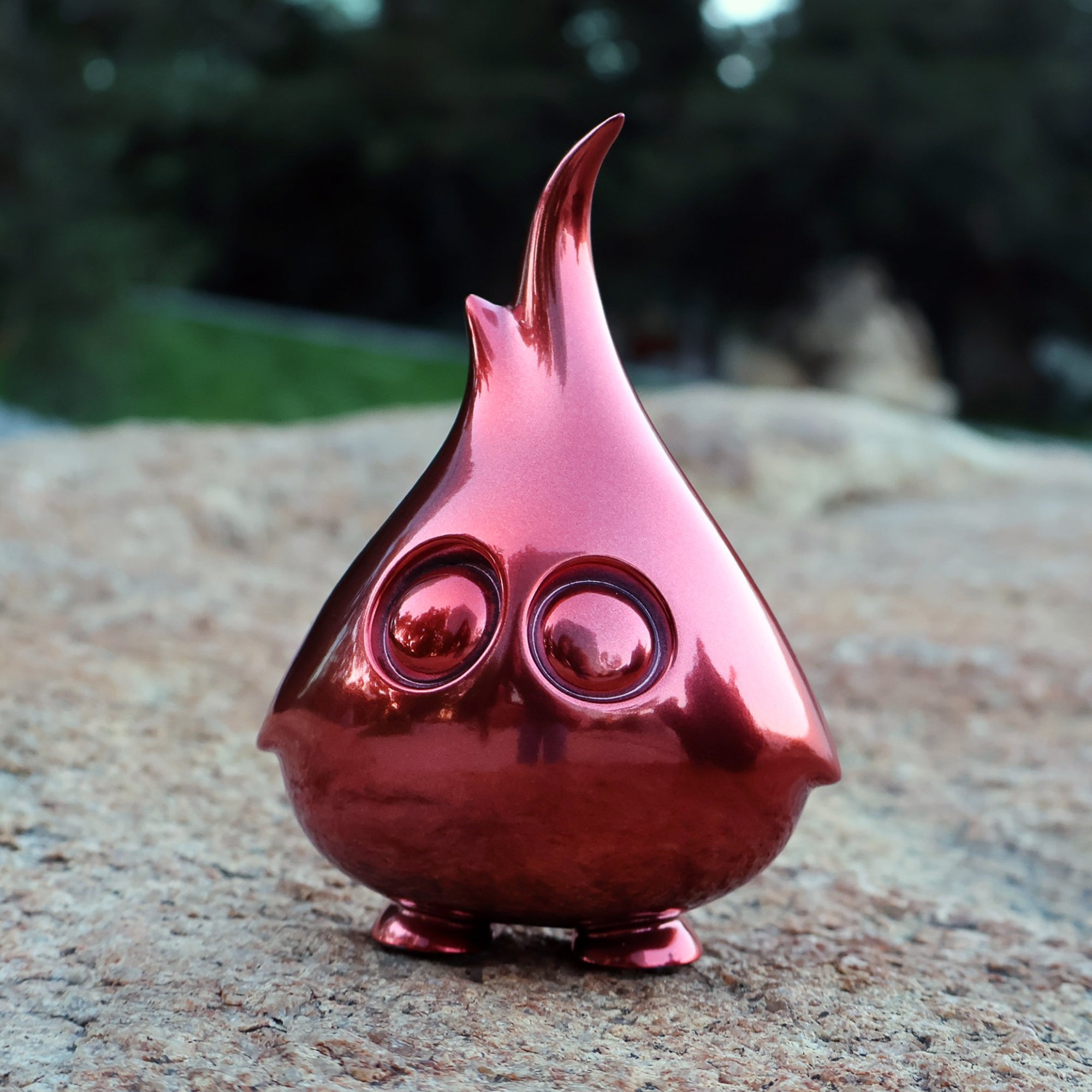 Mossy, a resin art toy by Artiqfox X Riser13, featuring two eyes, resting on a rock. Limited edition of 75 pieces. 5cm tall.