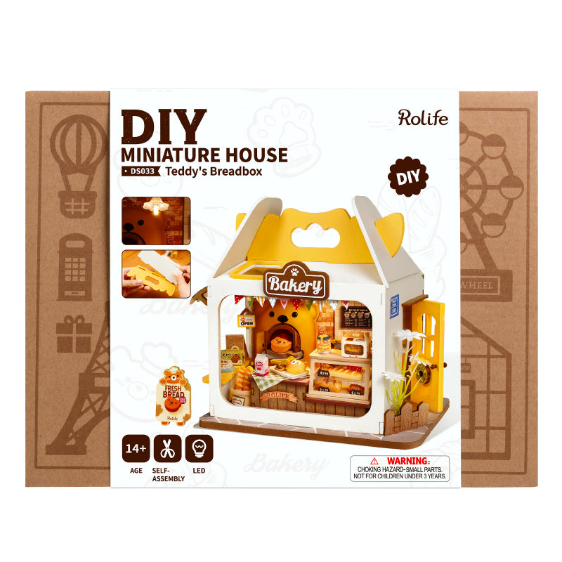 Teddy’s Breadbox Diy Miniature House in a yellow and white box, featuring a toy bakery with whimsical details like a cartoon cat label.