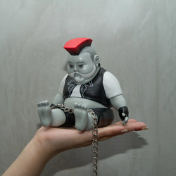 JIM DREAMS CHUNK PUNK figurine held in hand, toy head with red square, silver chain detail.