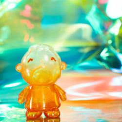 A small rubber ducky toy with a sad face, part of the MINNA NO TABO CRYSTAL PARADE EDITION collection by SANRIO.