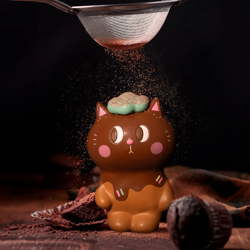 KIYO NEKO 'CHOCOLATE' EDITION: Chocolate cat figurine with powder falling from a sieve, toy, muffin, and more in close-up shots.