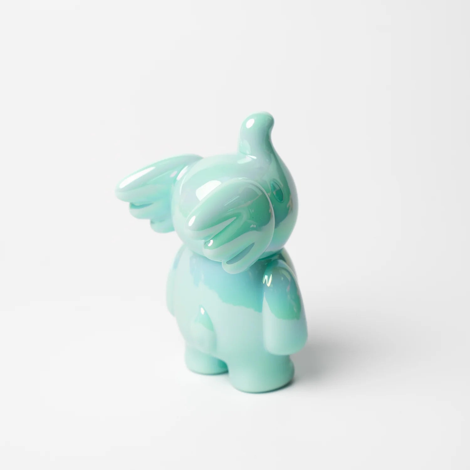 A small blue vinyl figurine with wings, titled ELFIE HERE I AM! 100% TIFFANY BLUE EDITION by Too Natthapong, approximately 3 inches tall.