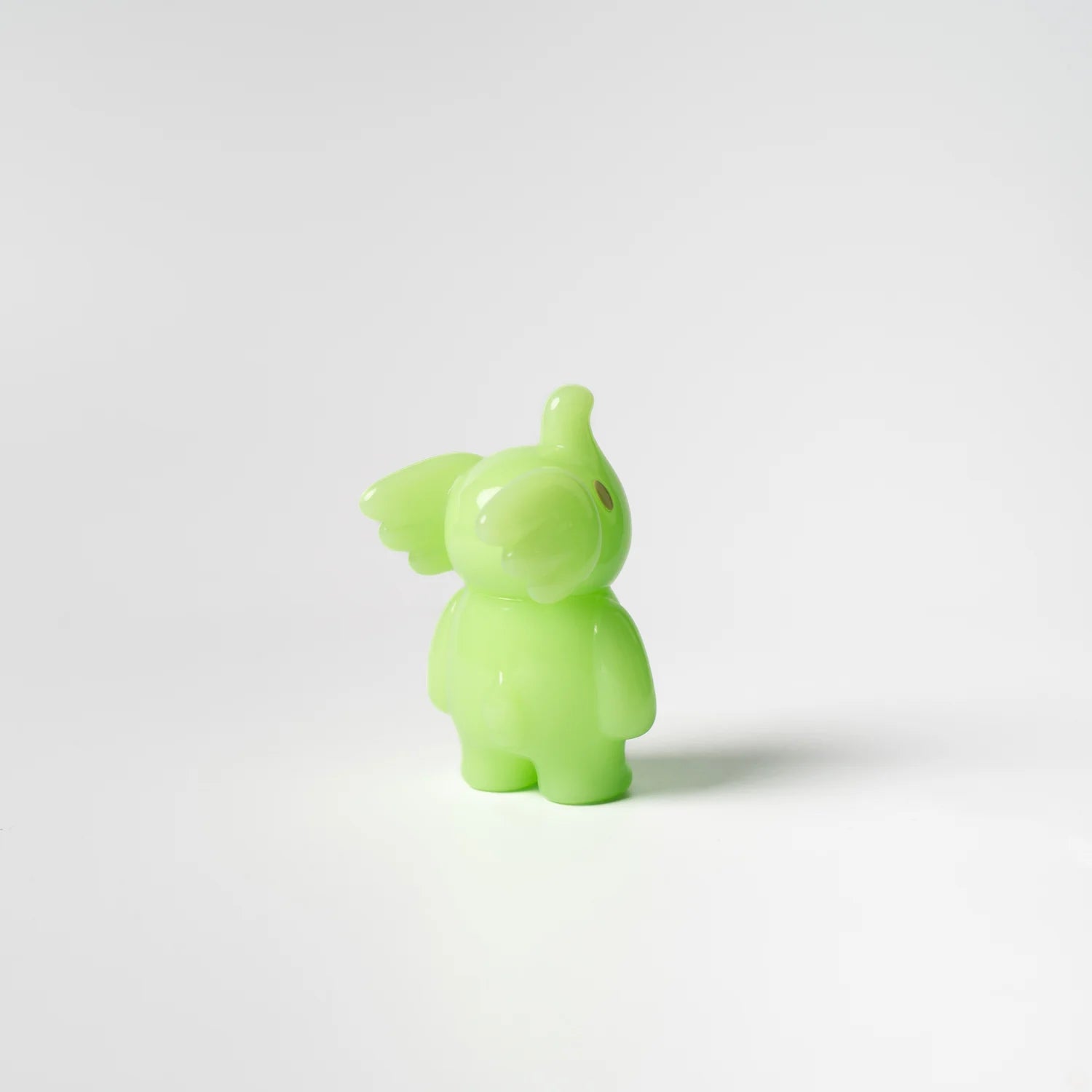 A lime green toy animal figurine with wings, Elfie Here I Am! Lime Edition by Too Natthapong, standing 3 inches tall. From Strangecat Toys, a blind box and art toy store.