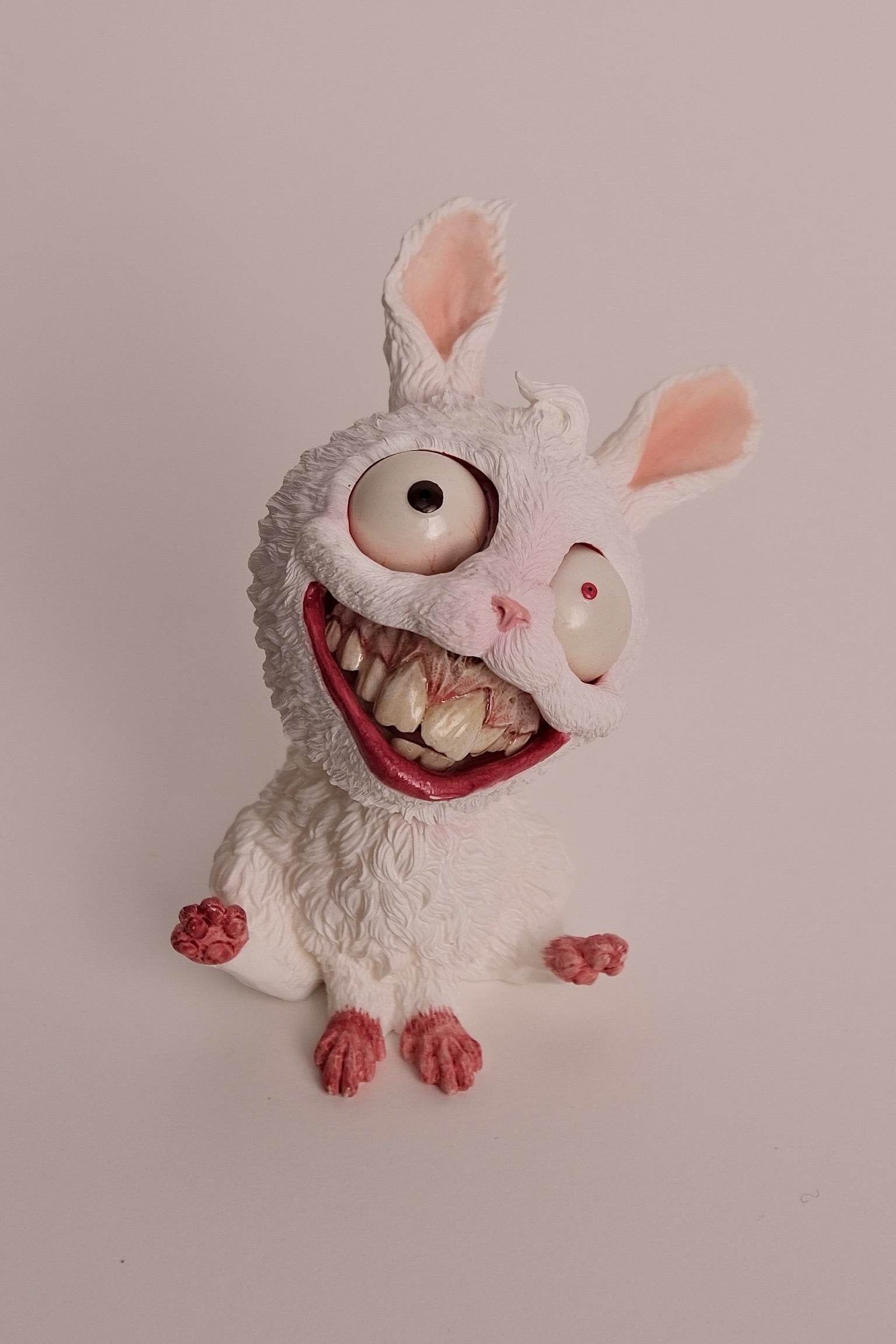 Chinese Zodiac-Year of Rabbit - Preorder: A toy rabbit with big eyes and teeth, a donut, and a cat's mouth.