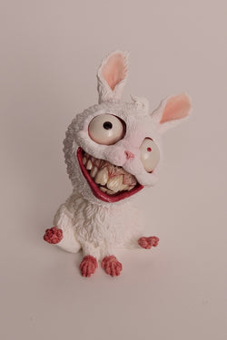 Chinese Zodiac-Year of Rabbit - Preorder: A toy rabbit with big eyes and teeth, a donut, and a cat's mouth.