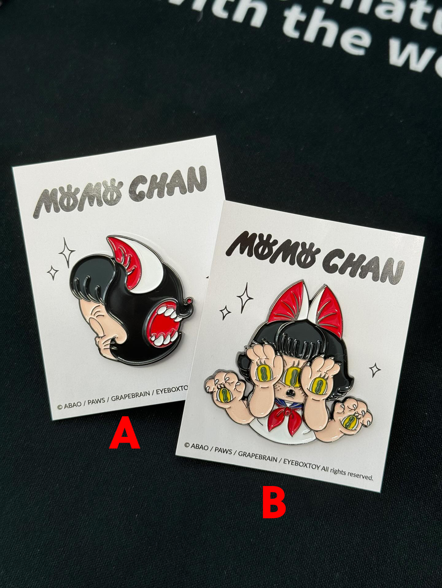 Momochan Pin by Abao x Grape Brain, featuring a cartoon character with hands over eyes on an acrylic pin, available for preorder, ships August 2024.