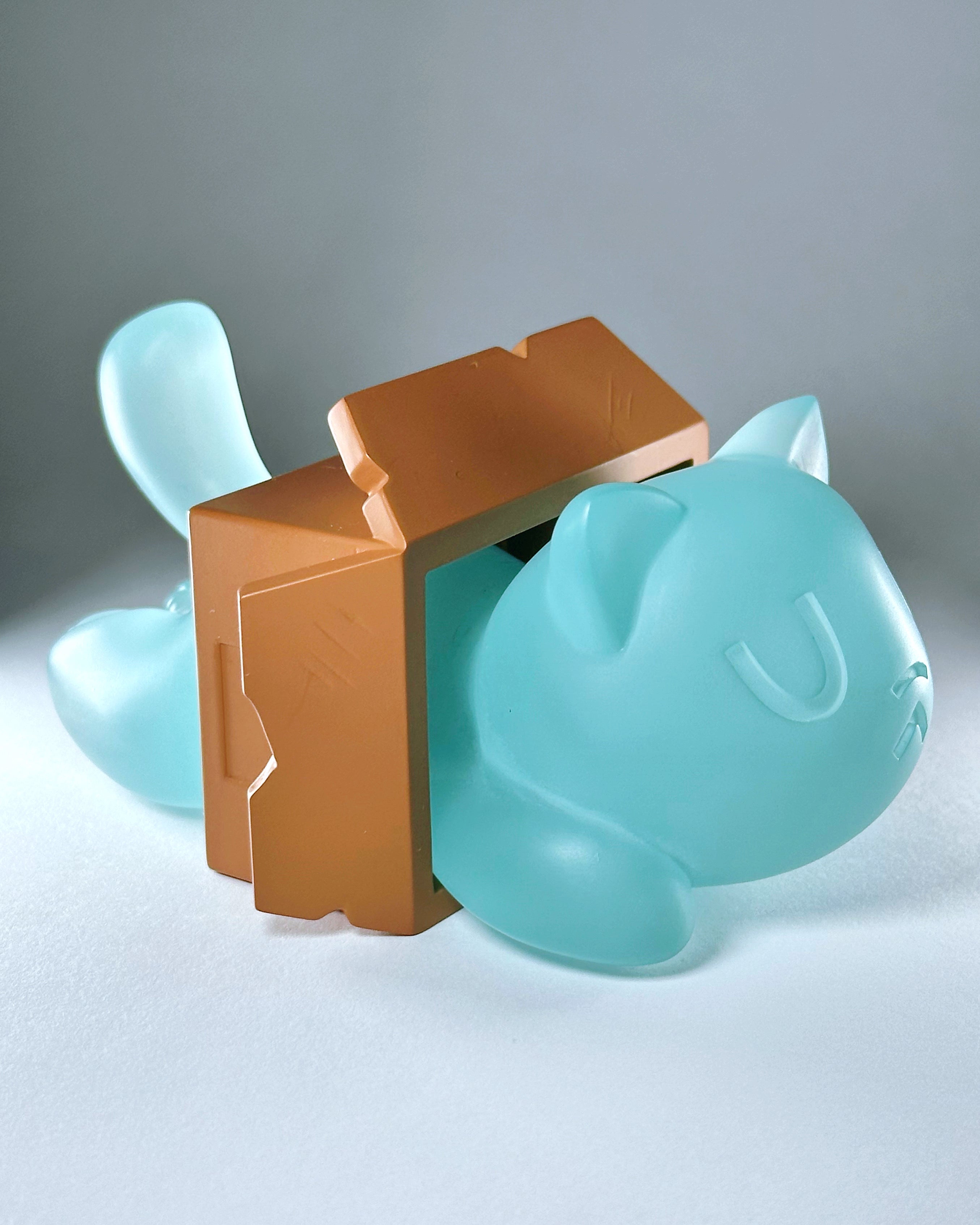 Little Mort by Saint Monday, a resin cat-shaped toy with magnets, 5” long, housed in a brown box, available for preorder.