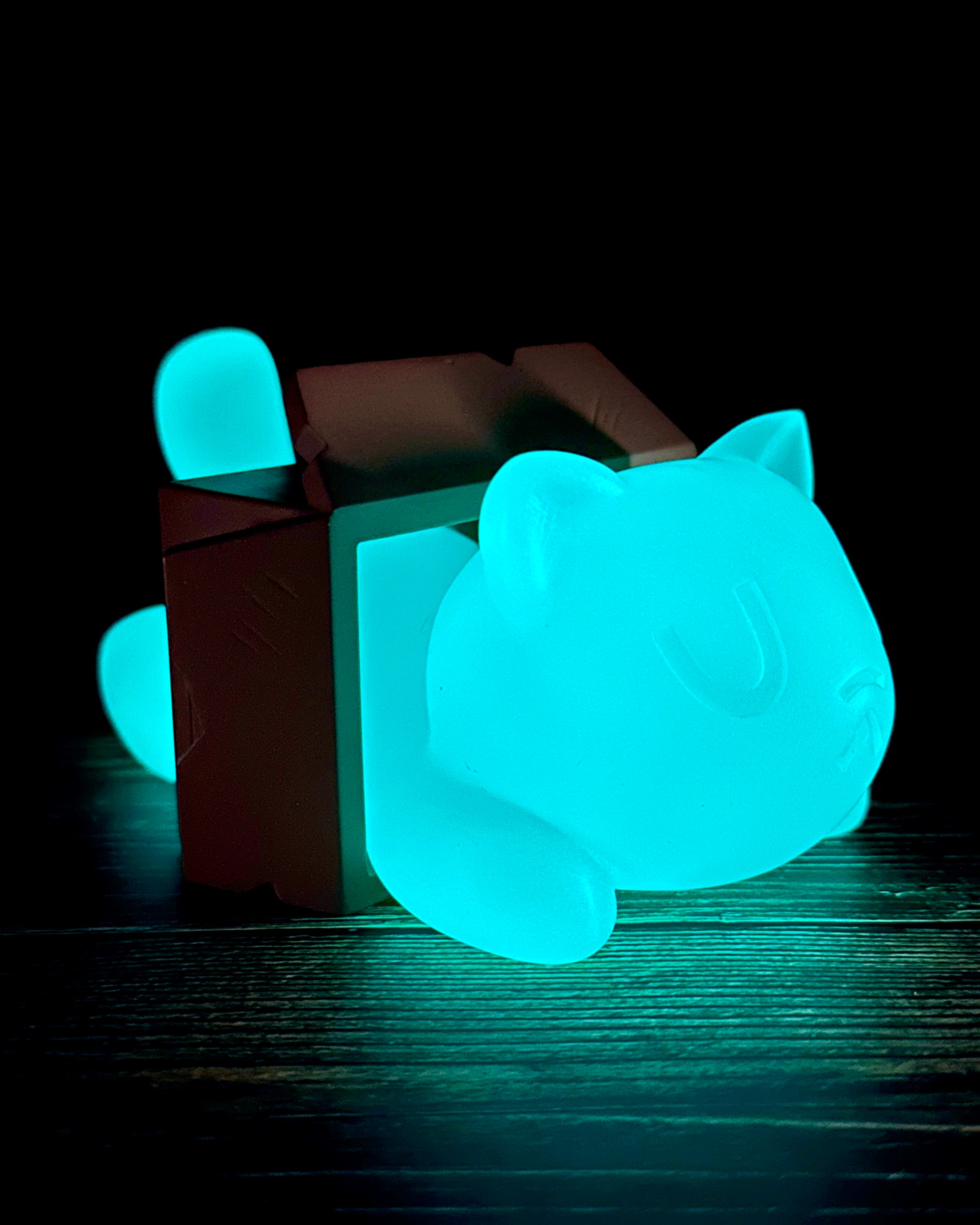 Little Mort by Saint Monday, a glowing resin toy cat, features three magnet parts, measuring 5” long, 4” wide, and 2.5” tall. Preorder for June 2025.