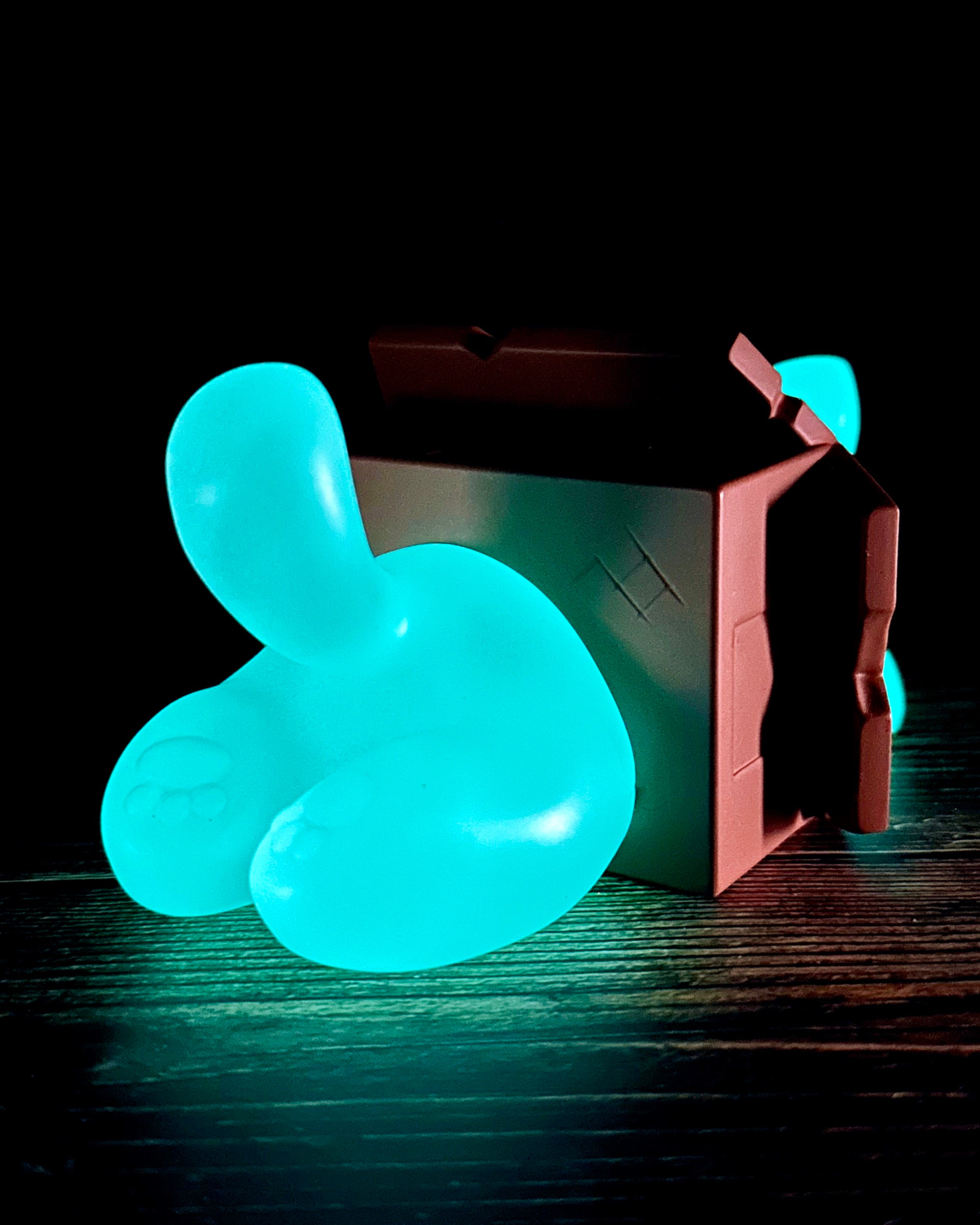 Little Mort by Saint Monday, a glow-in-the-dark resin toy, 5” long, 4” wide, 2.5” tall, featuring a magnetized three-part design.