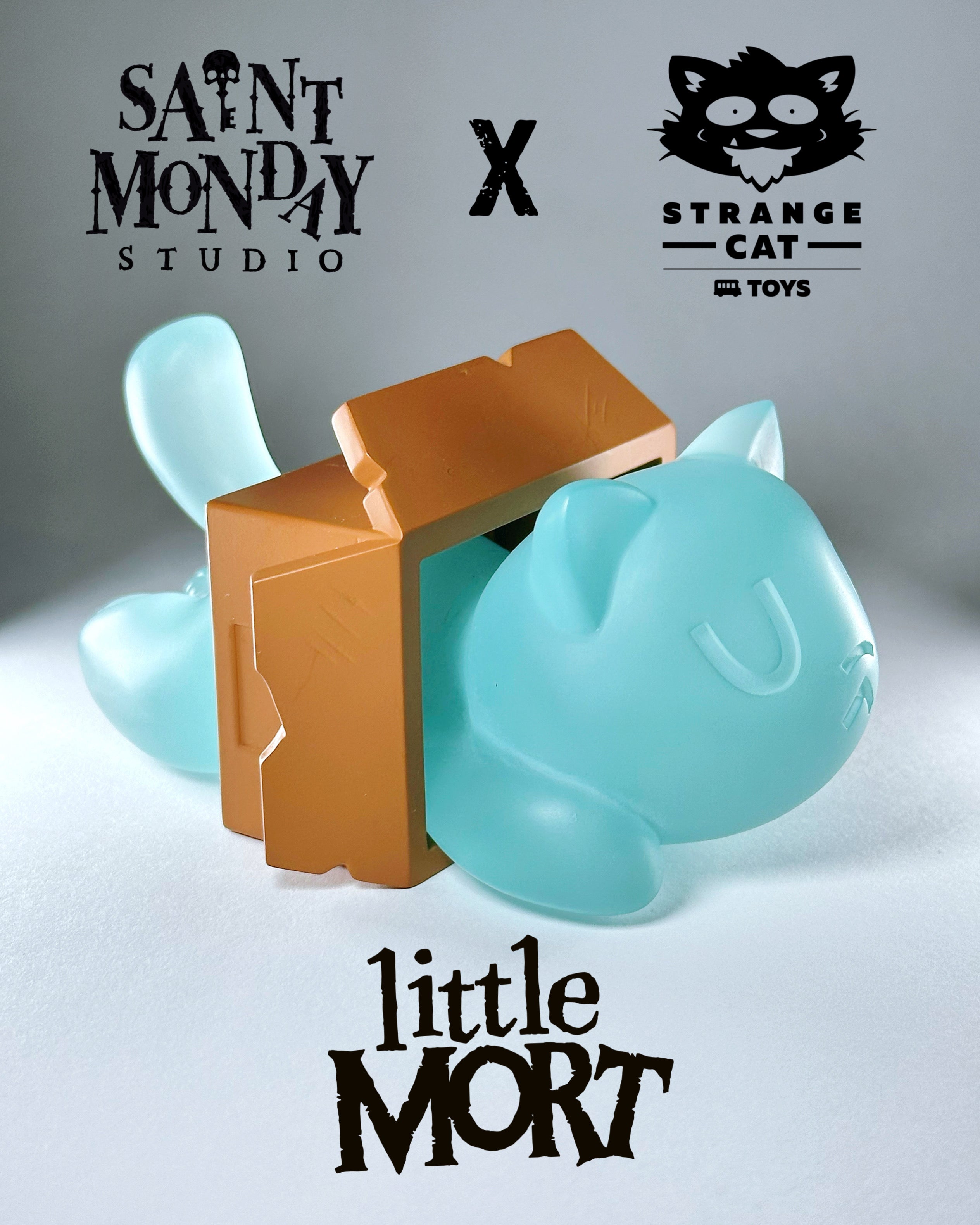 Little Mort by Saint Monday, a 5-inch blue resin toy cat, comes in a brown box with magnetic parts, available for preorder.