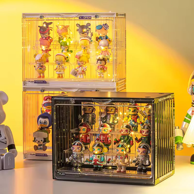 A showcase display case for toys, featuring a group of cartoon characters and toy robots. Preorder now for July 2024. Stackable design, ideal for collectors.