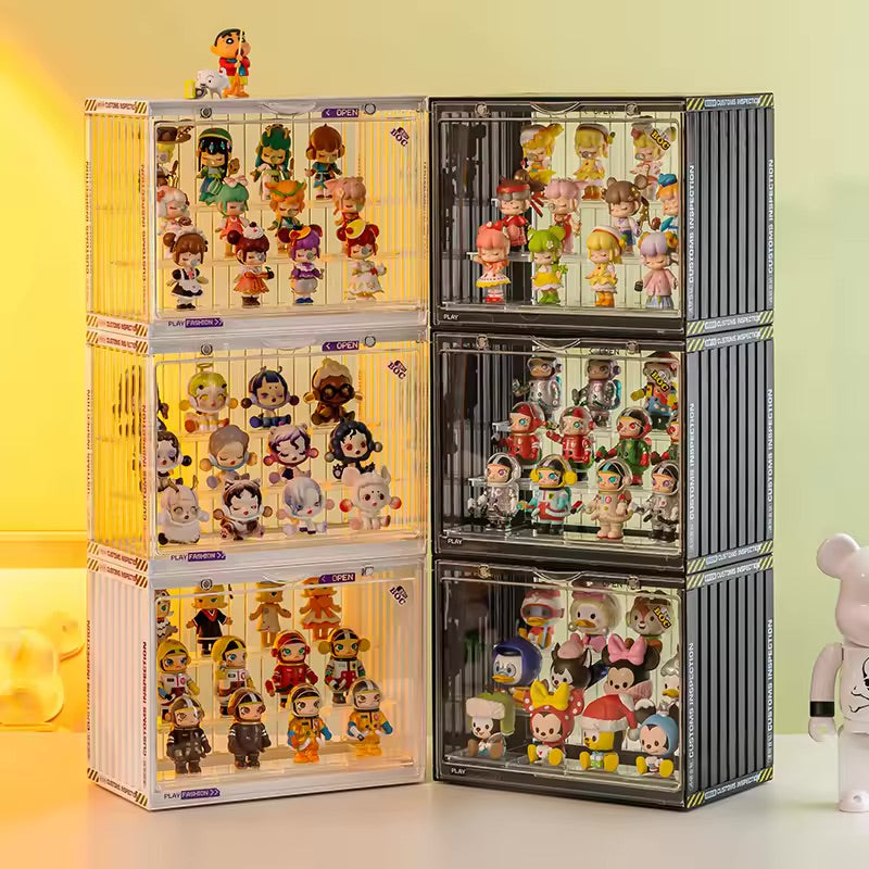 A group of toy display cases featuring cartoon characters and miniatures, stackable for easy storage. Preorder - Ships July 2024. From Strangecat Toys, a blind box and art toy store.