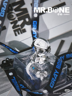 MR.BONE- white solomen toy in a clear plastic box, featuring a robot head design, part of a limited edition gift set from Strangecat Toys.