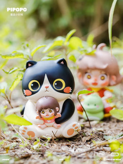 PIPOPO Return to Childhood Series Blind Box featuring a black and white cat figurine holding a doll among various toys on the grass. Preorder for March 2025.