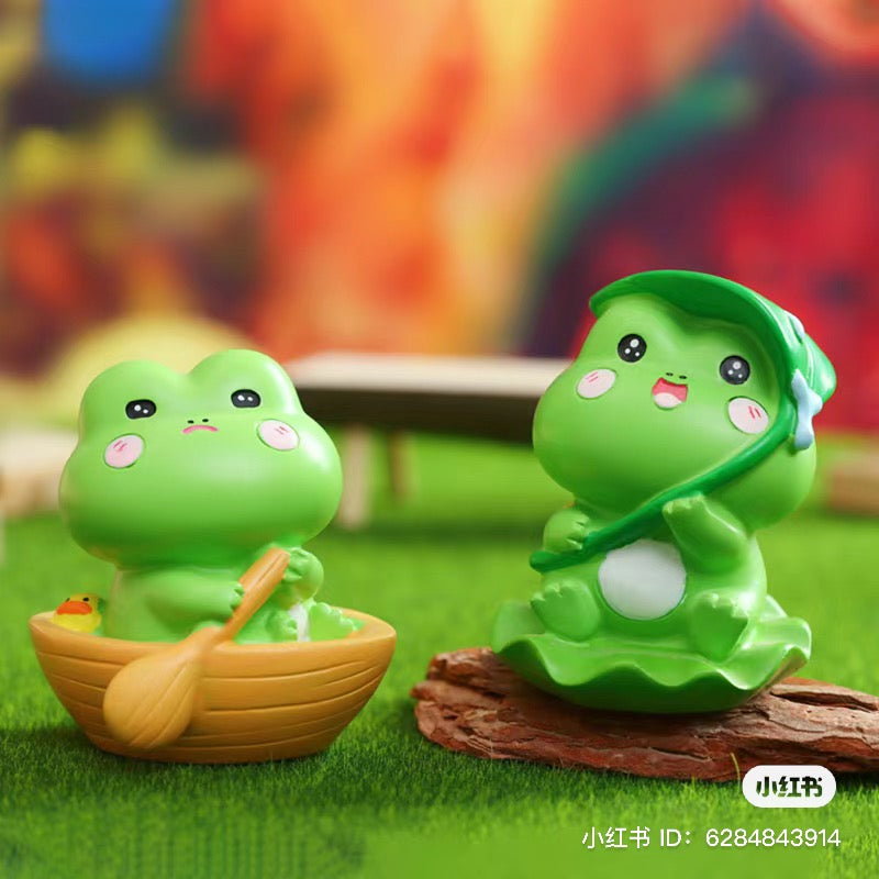 A blind box toy series featuring Autumn hidden by frog figurines. Includes 6 regular designs and 8 secrets. Available at Strangecat Toys.