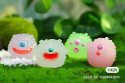 A group of toy figurines from the Little Monster Soft Candy Blind Box Series on a green surface. Includes 8 regular designs and 1 secret. Available at Strangecat Toys.