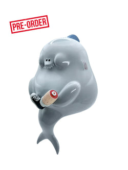 Toy whale with a paint roller on its back, close-up of a hand. Shark! by Sad Salesman - Preorder.