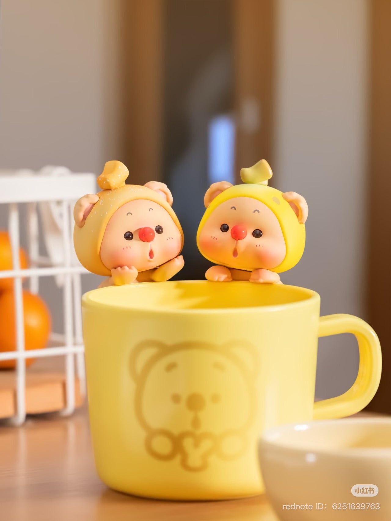 OYO Fruit Party HIPPER Blind Box Series figurines inside a yellow mug, showcasing playful toy designs from Strangecat Toys.