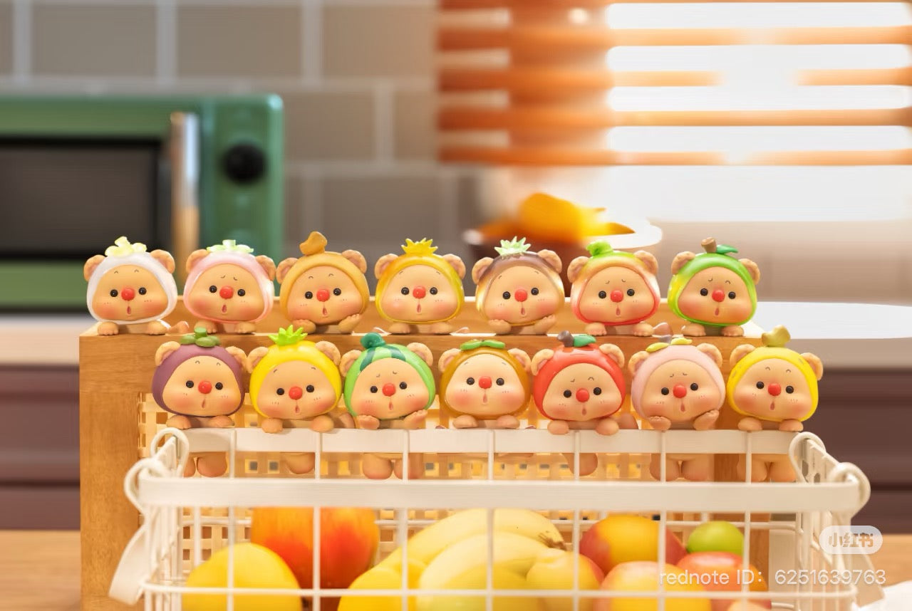 OYO Fruit Party HIPPER Blind Box Series figurines in a basket, showcasing diverse toy designs with adhesive for easy attachment.