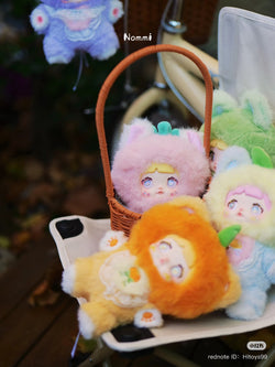 Nommi Interesting Fruit Series Plush Blind Box features diverse stuffed toys in a basket, highlighting the collectible nature of Strangecat Toys' art toy offerings.