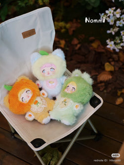 Nommi Interesting Fruit Series Plush Blind Box featuring various stuffed animals on a chair, part of a collectible set from Strangecat Toys.