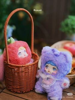 Nommi Interesting Fruit Series Plush Blind Box toys in a basket, showcasing two plush designs. Perfect for collectors of unique stuffed toys.