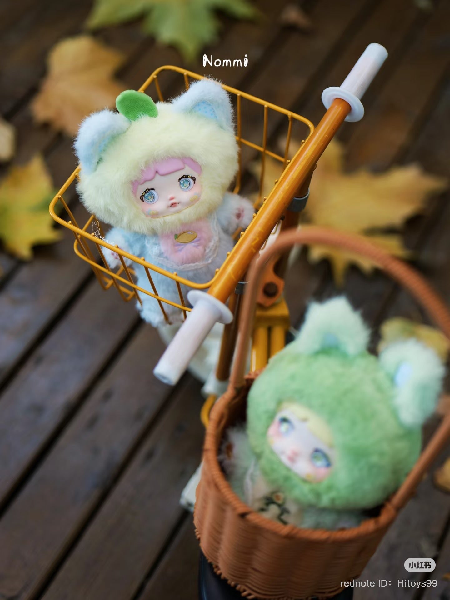 Nommi Interesting Fruit Series Plush Blind Box toy doll in a basket on a bicycle, featuring unique designs and a secret version.