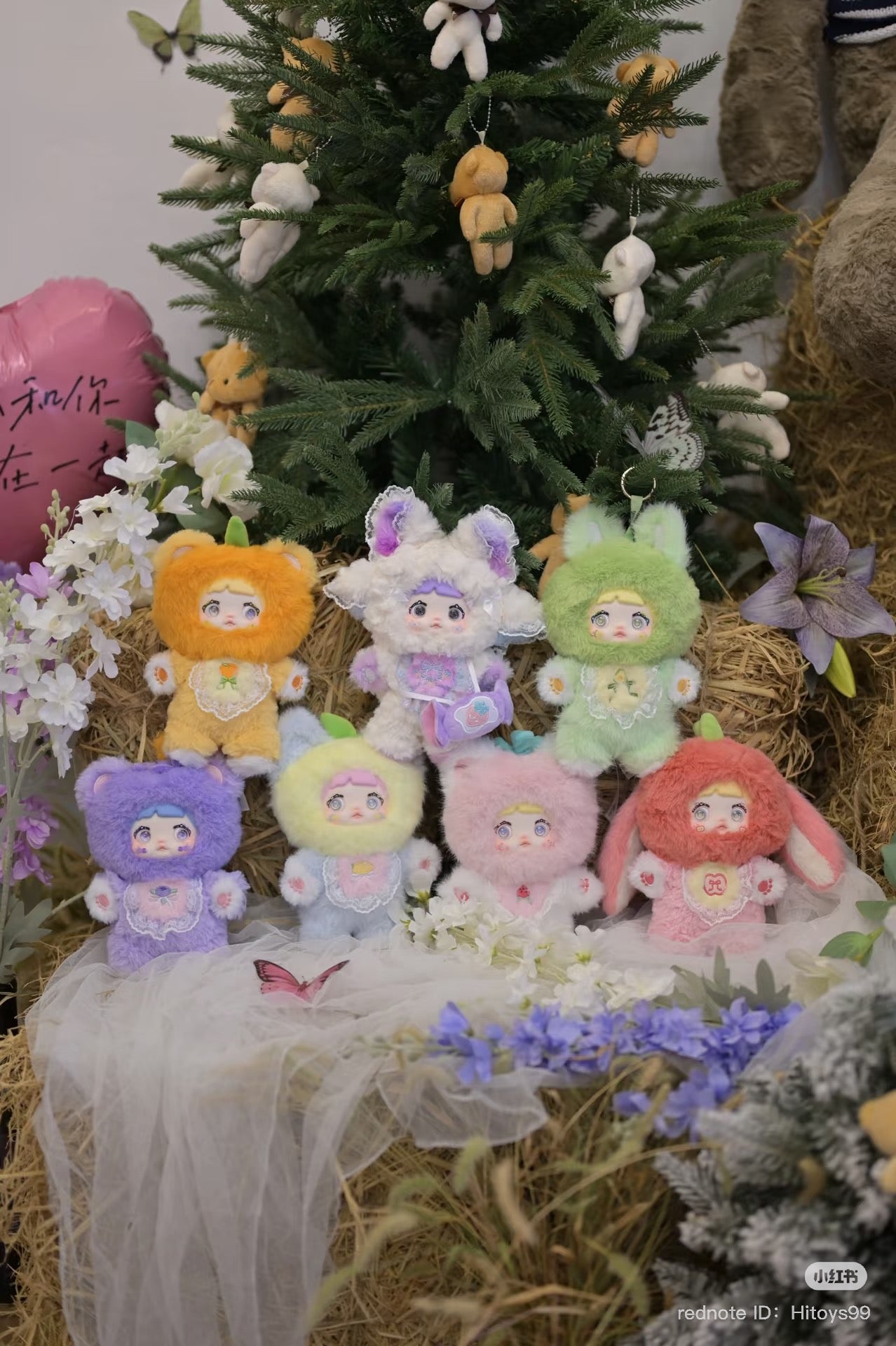 Nommi Interesting Fruit Series Plush Blind Box featuring various stuffed animals, including a secret design, displayed by a Christmas tree.