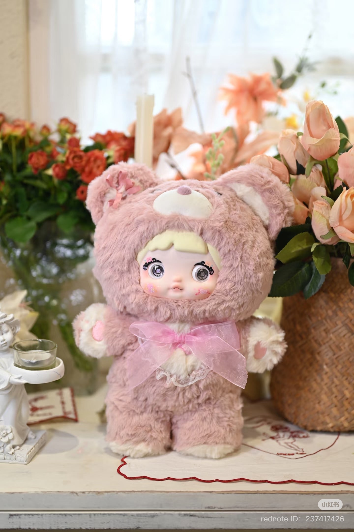 Nommi - 400% Goodnight Bear Plush Series Blind Box featuring a plush bear doll in bear garment, displayed alongside flowers.