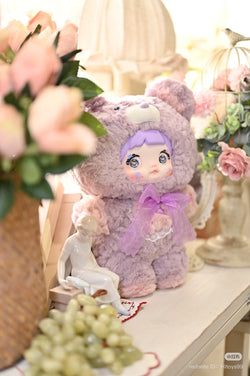 Nommi - 400% Goodnight Bear Plush Series Blind Box featuring a plush toy beside a decorative statue, emphasizing collectible art toys.