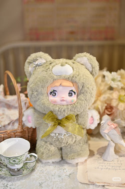 Nommi - 400% Goodnight Bear Plush Series Blind Box featuring a stuffed animal doll with a bow, accompanied by a teacup and saucer.