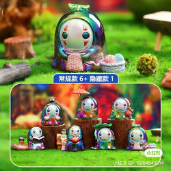 A group of small figurines from the No Face Man Blind Box Series displayed on grass.