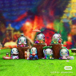 A group of small figurines from the No Face Man Blind Box Series displayed on a grass field.