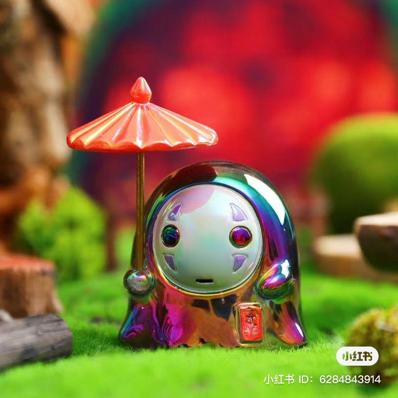 Alt text: No Face Man Blind Box Series toy umbrella on grass, part of a collectible set with secret designs.