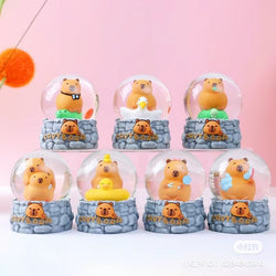 A collection of Capybara Snow Globe Blind Box Series toys, featuring miniature snow globes with bears and various designs.