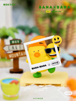Toy figurine of a yellow duck with sunglasses holding a picture frame from the BANA×BANA emoji Playground Micro Box Pro Blind Box Series.
