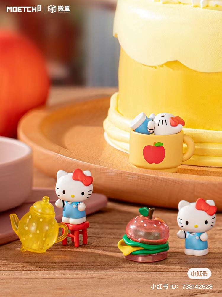 Hello Kitty Big Apple Workshop Series Mini Box featuring various toys, including a yellow teapot, plastic burger, and cake with cartoon character.