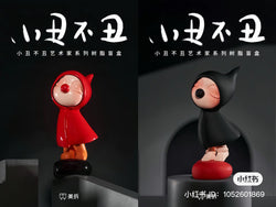 Alt text: Two figurines from the Joker Not Joker Blind Box Series, featuring a girl and a cartoon character in a black hooded garment. Preorder for July 2024.