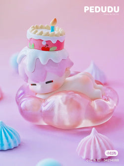 Alt Text: PEDUDU Lies on Cloud Blind Box toy with a cake and candle on top, part of a preorder series shipping Aug 2024.