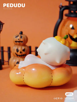 Toy cat figurine lying on a pumpkin from the PEDUDU Lies on Cloud Blind Box Series, available for preorder, shipping in August 2024.