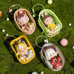 Toy Pochette Keychain in a transparent case with miniature plastic toys, featuring bells, rings, and hairballs for doll display.