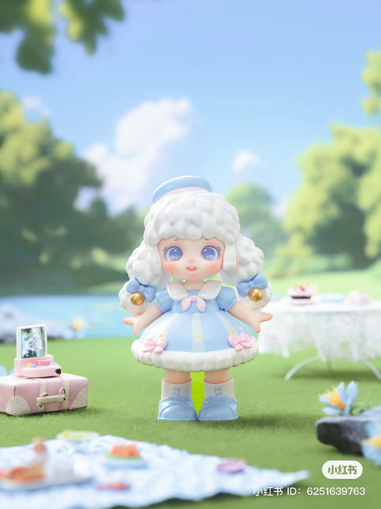 Alt text: Miana - Tea Party In The Forest Blind Box Series: Toy doll with white hair and blue dress on grass.