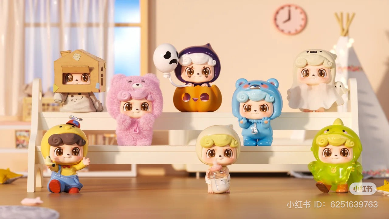 Be Your Q Baby Blind Box Series, featuring small toys and figurines, displayed on a shelf. Preorder for August 2024, includes 6 regular designs and 2 secret options.