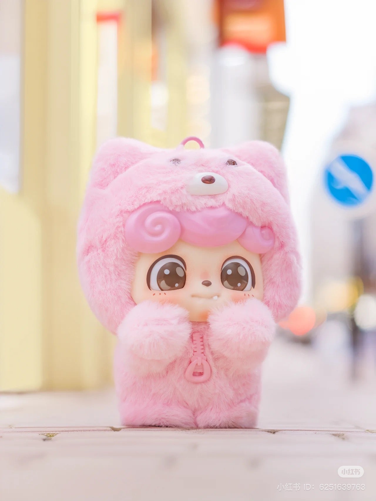 Pink stuffed animal with big eyes from the Be Your Q Baby Blind Box Series, available for preorder, featuring 6 designs and 2 secret options.