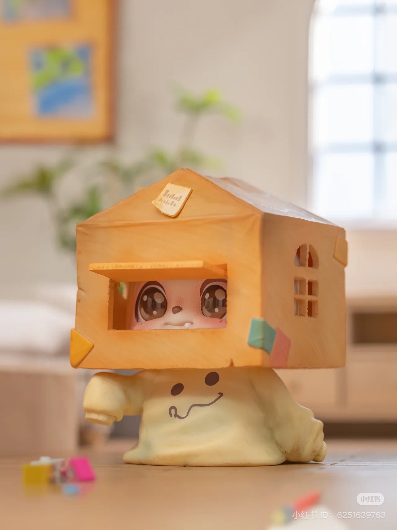 Be Your Q Baby Blind Box Series featuring a toy figurine with a house on its head, available for preorder, ships August 2024.