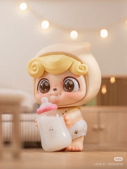 Be Your Q Baby Blind Box Series toy doll holding a baby bottle, part of a preorder collection with 6 regular and 2 secret designs. Ships Aug 2024.