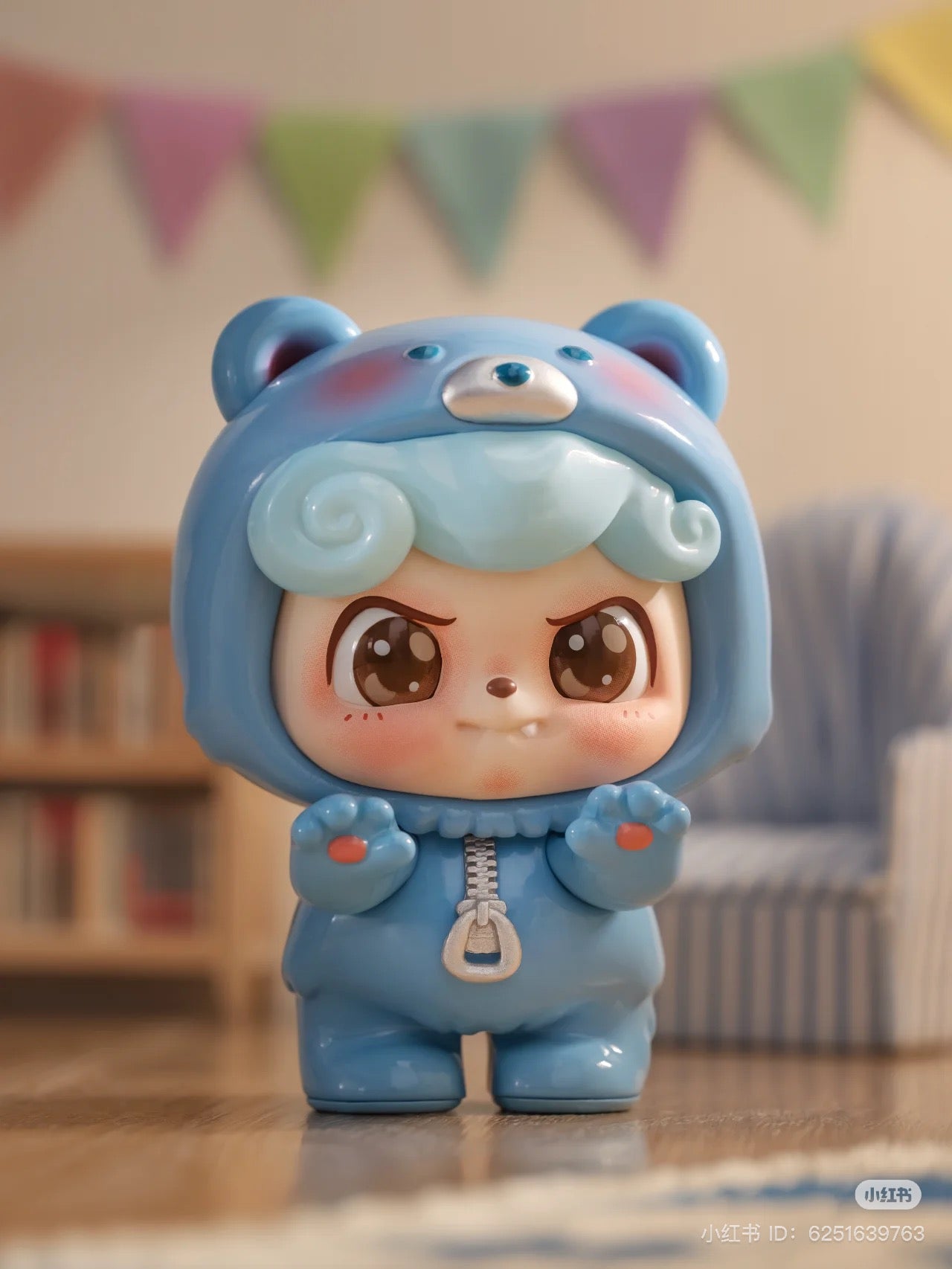 Be Your Q Baby Blind Box Series: A toy figurine of a baby in a blue bear garment, featuring 6 designs and 2 secret variants, ships Aug 2024.