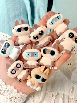 Hand holding a group of MINI Azukisan ver 1 stuffed toys from the Blind Box Series, available for preorder, shipping August 2024.