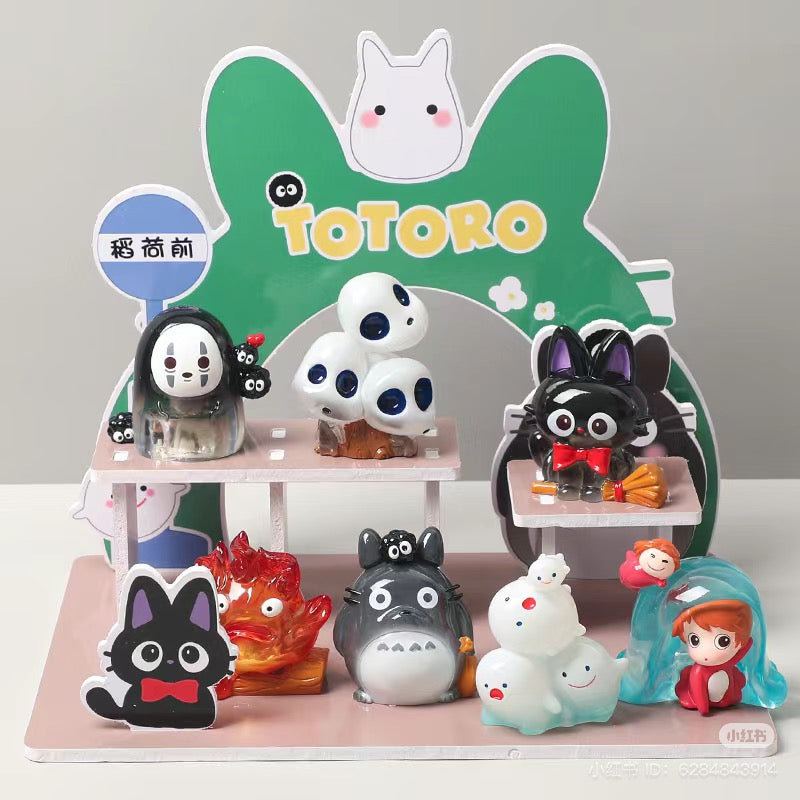 Group of Totoro Blind Box Series toys on a shelf, featuring various characters including a cartoon cat with a bow tie and a boy figurine.